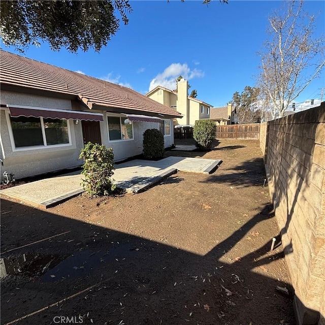 view of yard with a patio area and a fenced backyard