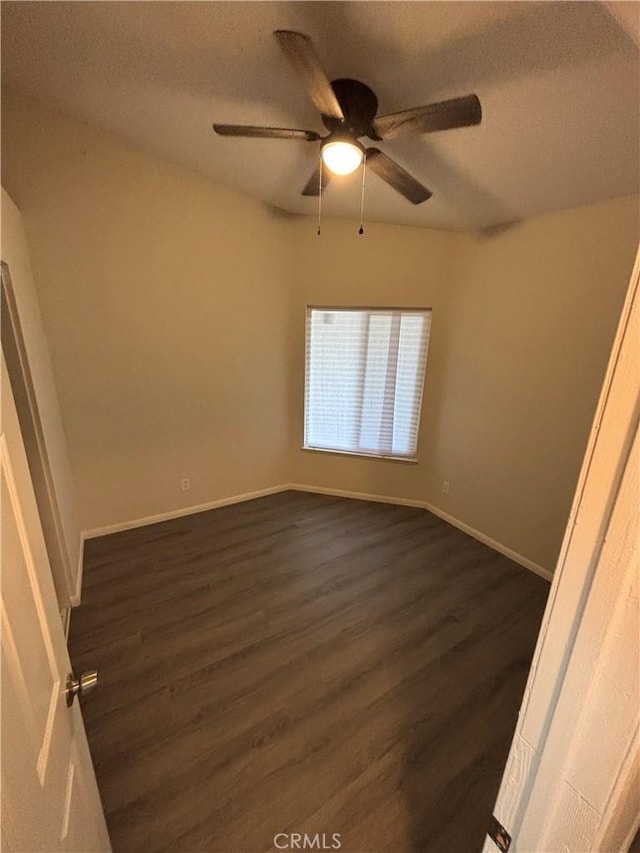 unfurnished bedroom with ceiling fan, baseboards, a textured ceiling, and dark wood finished floors