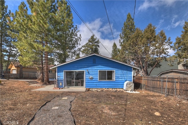 rear view of property with fence