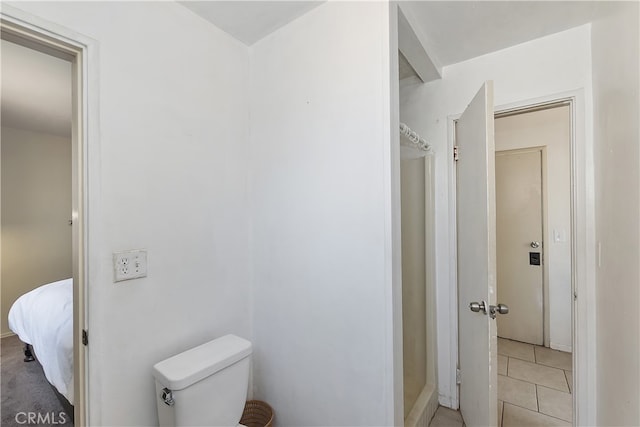 bathroom featuring toilet and tile patterned flooring