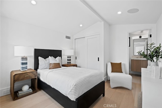 bedroom featuring visible vents, lofted ceiling, recessed lighting, light wood-style floors, and a closet