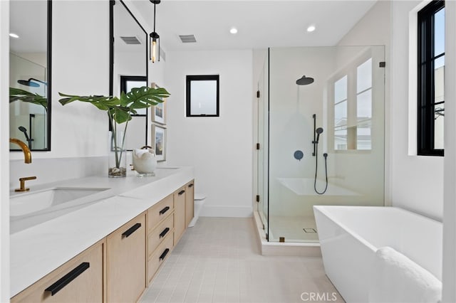 bathroom with vanity, visible vents, a freestanding tub, a shower stall, and tile patterned floors