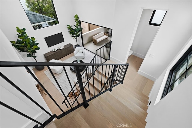 stairs with baseboards and wood finished floors