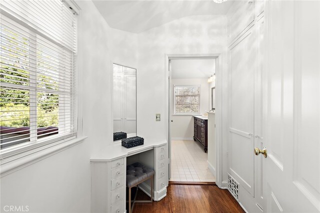 office space with dark wood finished floors, visible vents, a healthy amount of sunlight, and baseboards