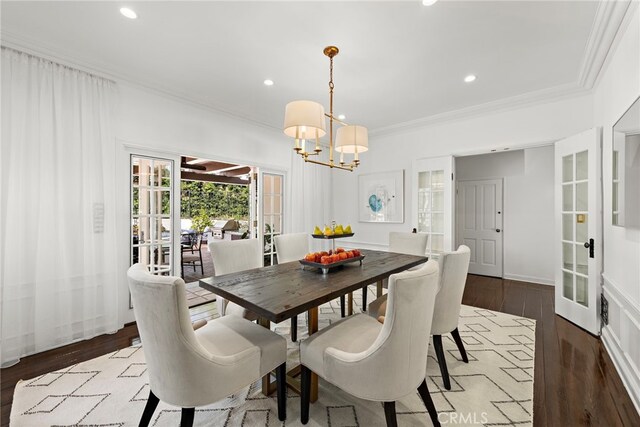 dining room featuring french doors, an inviting chandelier, ornamental molding, and hardwood / wood-style flooring