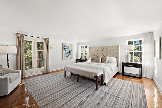 bedroom with baseboards and wood finished floors