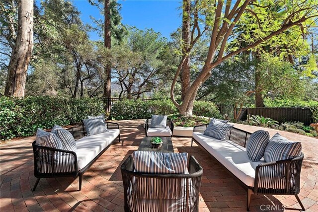 view of patio featuring an outdoor living space and fence