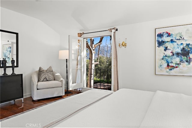 bedroom featuring lofted ceiling, wood finished floors, and access to outside