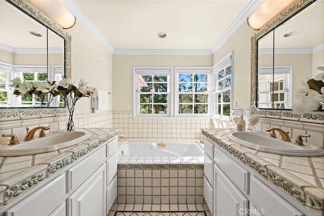 bathroom with a sink, a bath, and crown molding