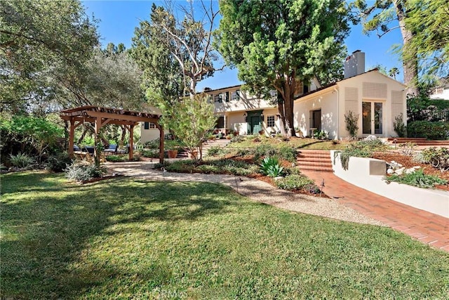 view of yard with french doors and a pergola