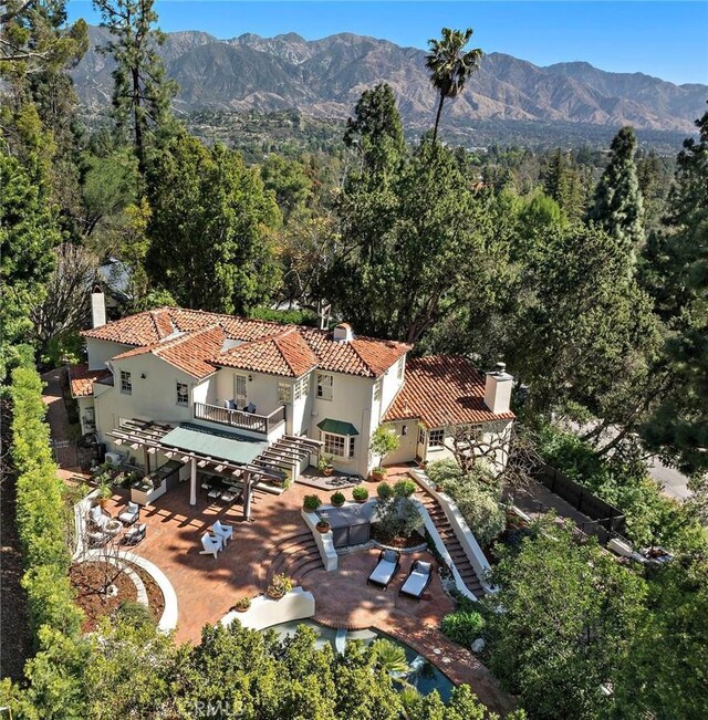 drone / aerial view with a mountain view and a wooded view