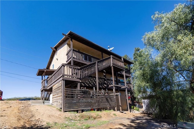 back of house featuring stairway