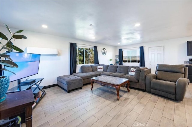 living area with a wealth of natural light, light wood-style floors, and recessed lighting