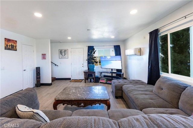 living room featuring stairway, recessed lighting, baseboards, and light wood-style floors