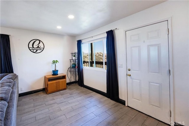 foyer with recessed lighting, baseboards, and light wood finished floors