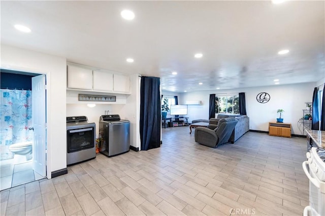 kitchen featuring baseboards, light wood-style flooring, recessed lighting, white cabinets, and white gas range