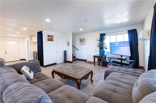 living room with stairway, recessed lighting, light wood-type flooring, and baseboards