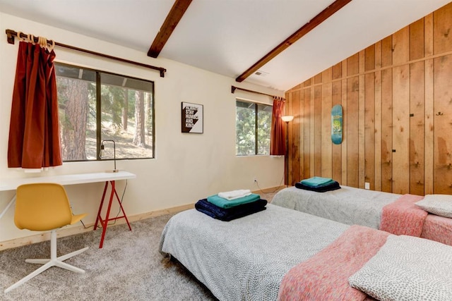 carpeted bedroom with lofted ceiling with beams and wooden walls