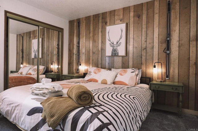 bedroom featuring carpet flooring, a closet, and wood walls