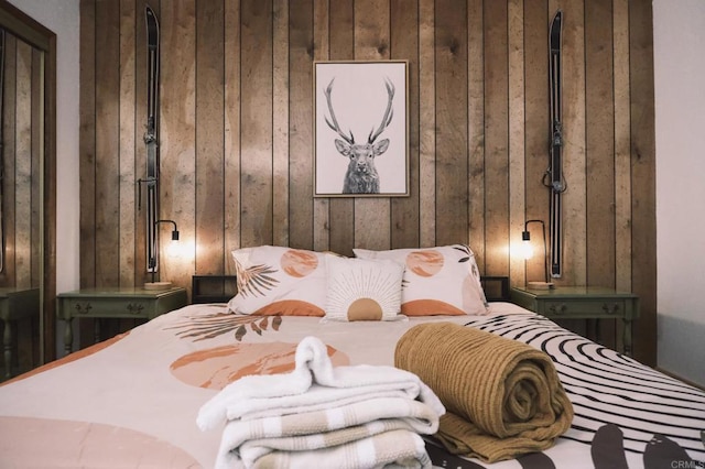 bedroom featuring wooden walls