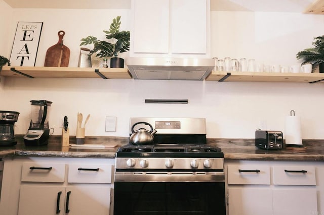 kitchen with under cabinet range hood, gas range, white cabinetry, and open shelves