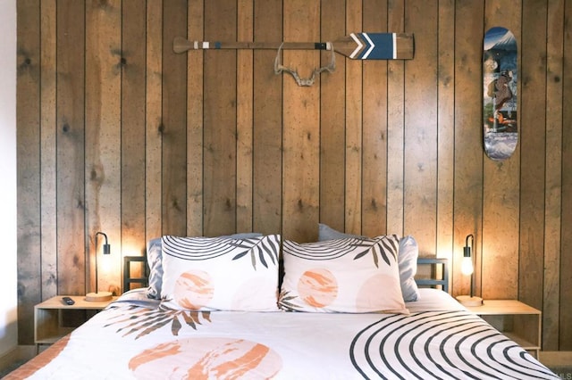 bedroom featuring wooden walls