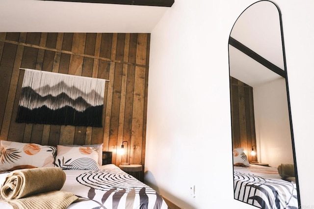 bedroom featuring wooden walls