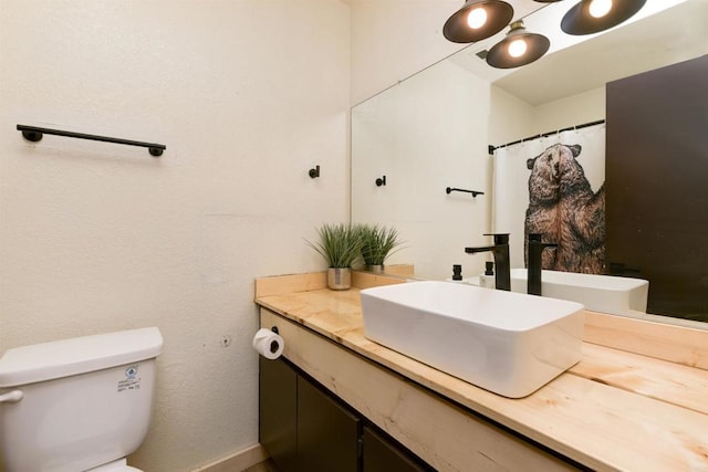 bathroom featuring toilet and vanity