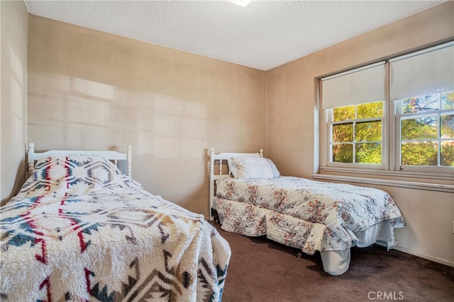 bedroom with a textured ceiling and carpet floors