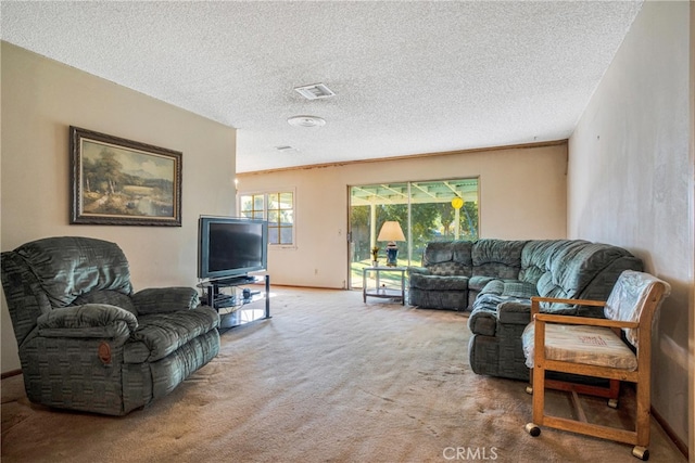 living area featuring visible vents, baseboards, a textured ceiling, and carpet flooring