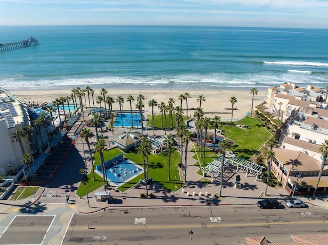 drone / aerial view featuring a water view and a beach view