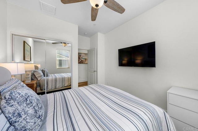 bedroom with a closet, visible vents, and a ceiling fan