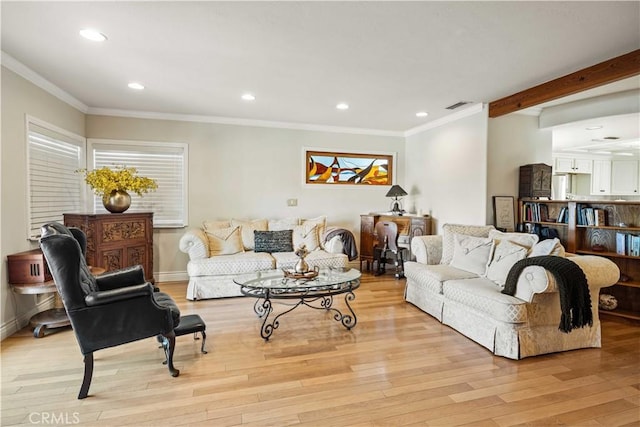 living area featuring crown molding, visible vents, and light wood-type flooring