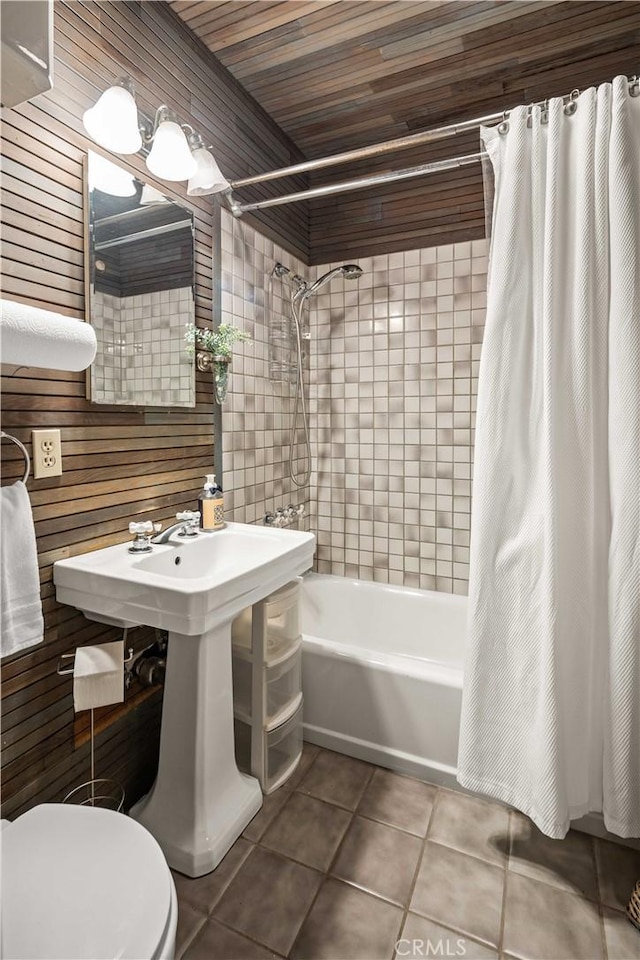 full bathroom with tile patterned flooring, toilet, and shower / tub combo with curtain