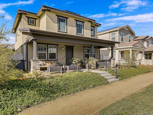 view of front of house featuring covered porch, an outdoor hangout area, and stucco siding