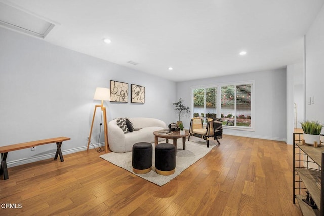 living room featuring recessed lighting, baseboards, and wood-type flooring