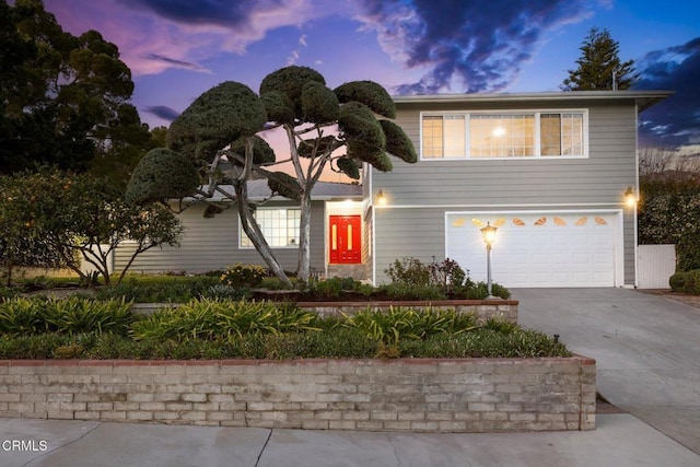 traditional-style house with an attached garage and concrete driveway