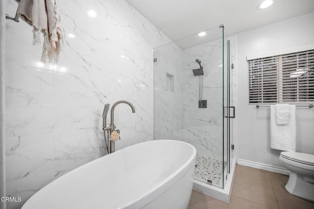 bathroom with a marble finish shower, recessed lighting, a freestanding bath, tile patterned flooring, and toilet