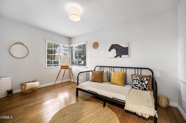 sitting room featuring baseboards and wood-type flooring