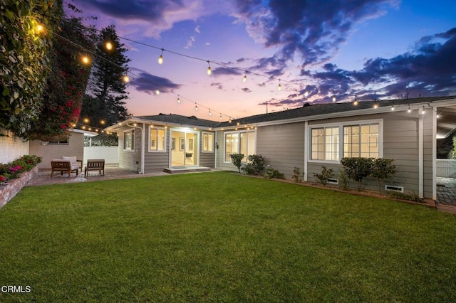 rear view of house with crawl space, a patio area, a lawn, and fence