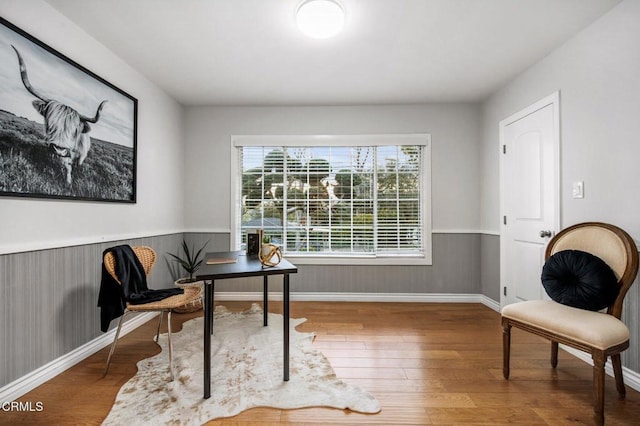 office space featuring wainscoting, baseboards, and wood finished floors