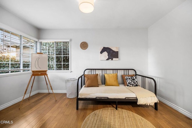 bedroom featuring baseboards and hardwood / wood-style flooring