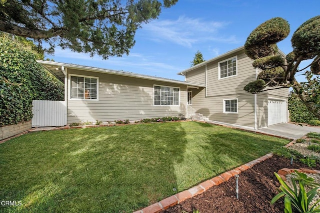 view of front of property with a garage, driveway, and a front yard