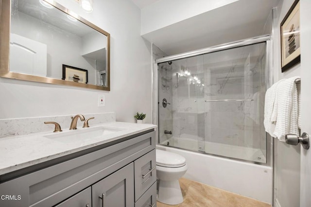 bathroom featuring vanity, toilet, and enclosed tub / shower combo