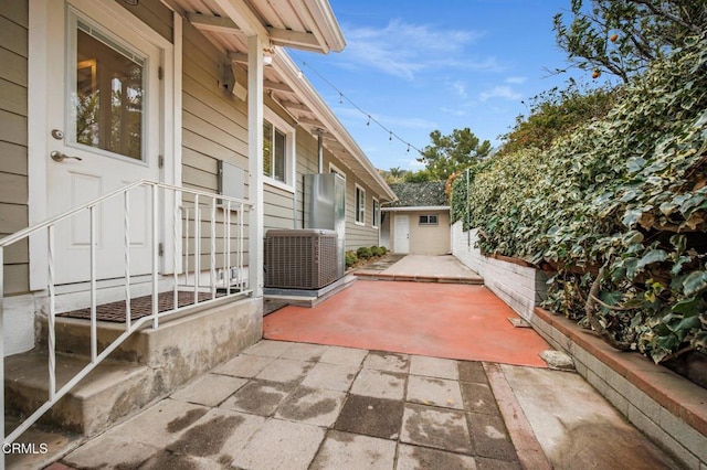 view of patio featuring an outbuilding and central AC unit