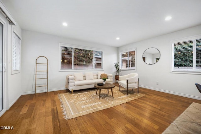 living area with recessed lighting, baseboards, and wood finished floors