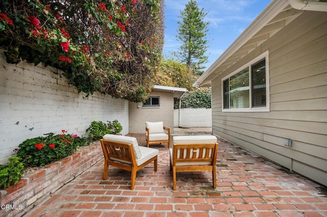 view of patio / terrace with an outdoor living space and fence