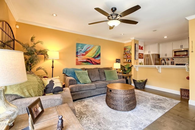 living room with recessed lighting, ornamental molding, a ceiling fan, and wood finished floors