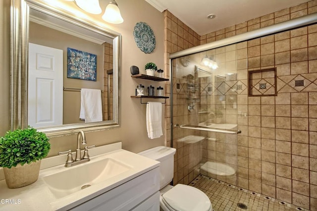 full bath featuring a shower stall, crown molding, toilet, and vanity