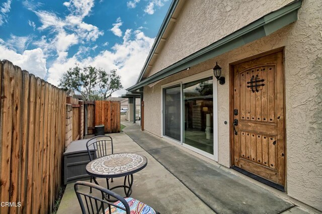 view of patio featuring fence